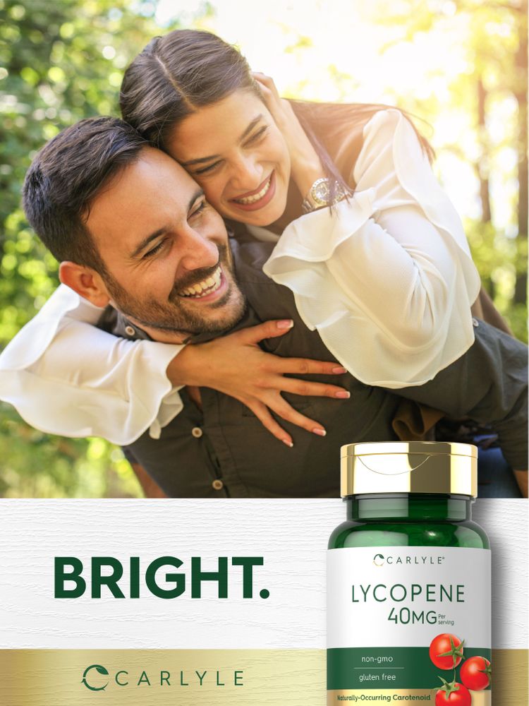 A young man and woman are embracing and laughing outdoors, with a Carlyle Lycopene 40 mg bottle nearby.