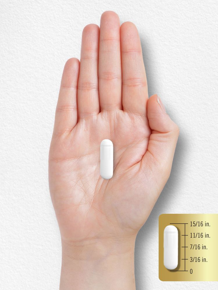 A white capsule measuring fifteen-sixteenths of an inch on a hand scale.
